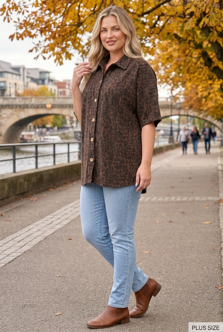 Plus-size blonde model in a half-side pose on the autumn riverside promenade