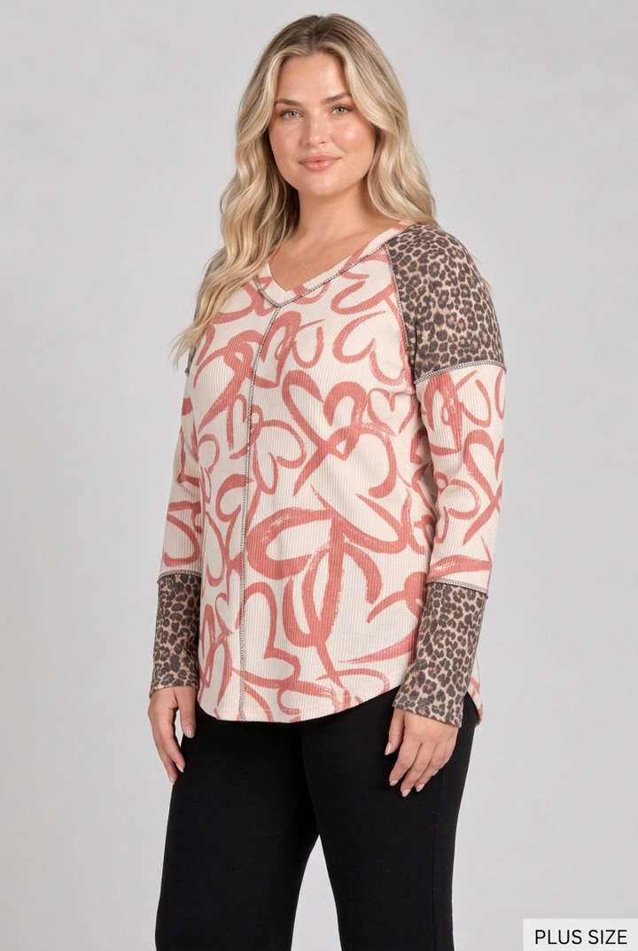 Plus-size blonde model in a side pose wearing the heart-and-leopard top