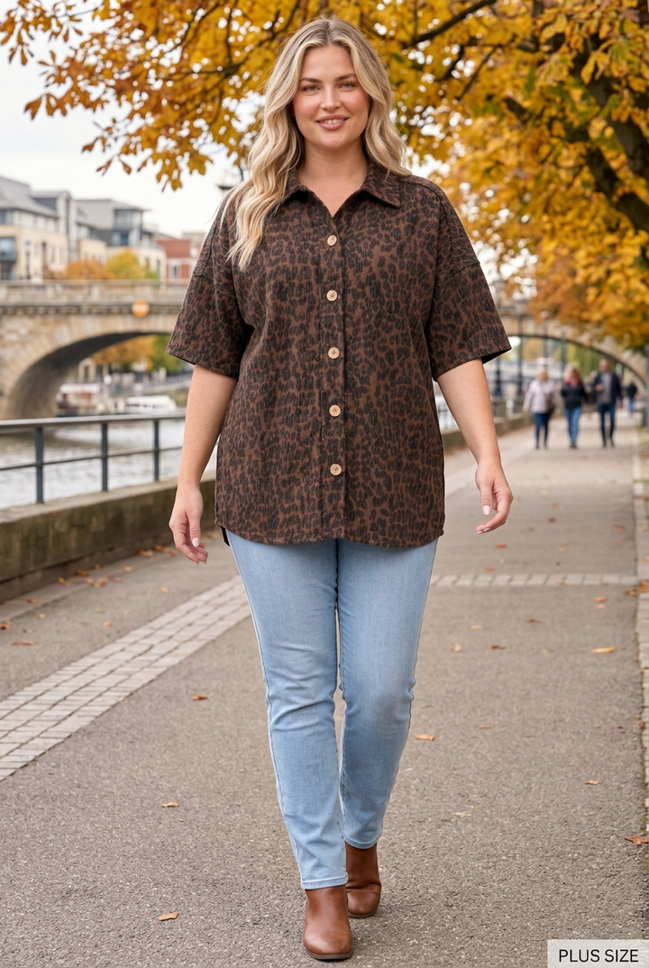 Plus-size blonde model wearing the dark leopard top on an autumn riverside promenade