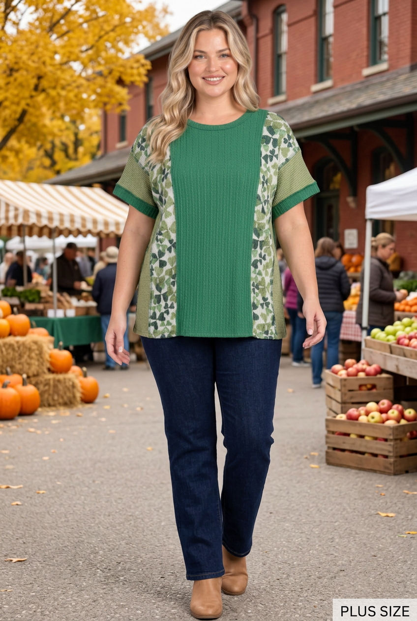 Plus-size blonde model wearing the green top and dark pants at an autumn market