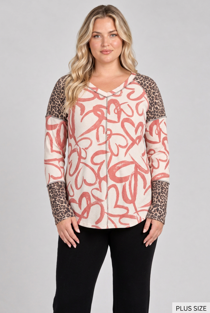 Plus-size blonde model wearing the heart-and-leopard top