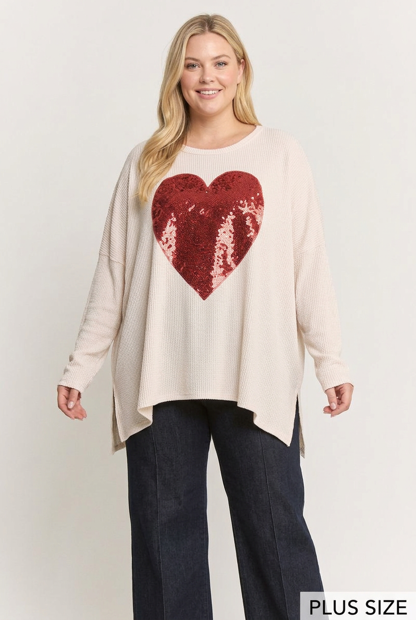 Plus-size blonde model wearing the ivory ribbed top with red sequin heart