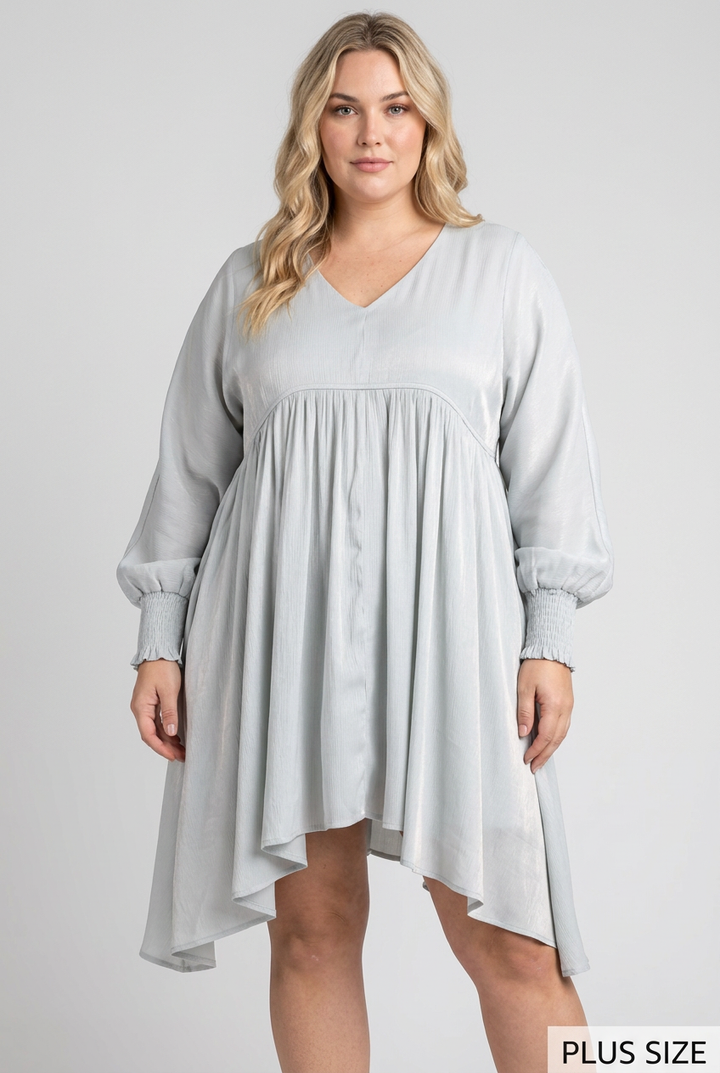 Plus-size blonde model wearing the pale blue-gray flowing dress