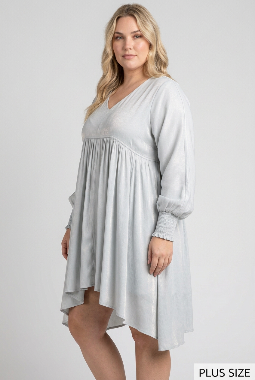 Plus-size side studio pose wearing the pale blue-gray dress