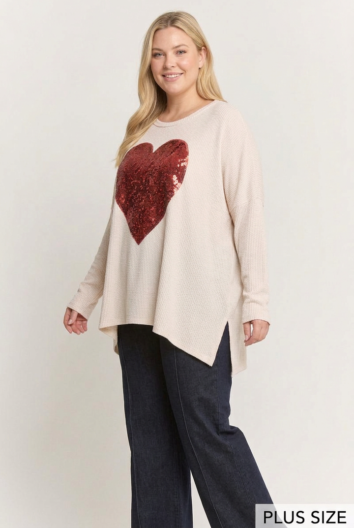 Plus-size side studio pose wearing the red sequin-heart top