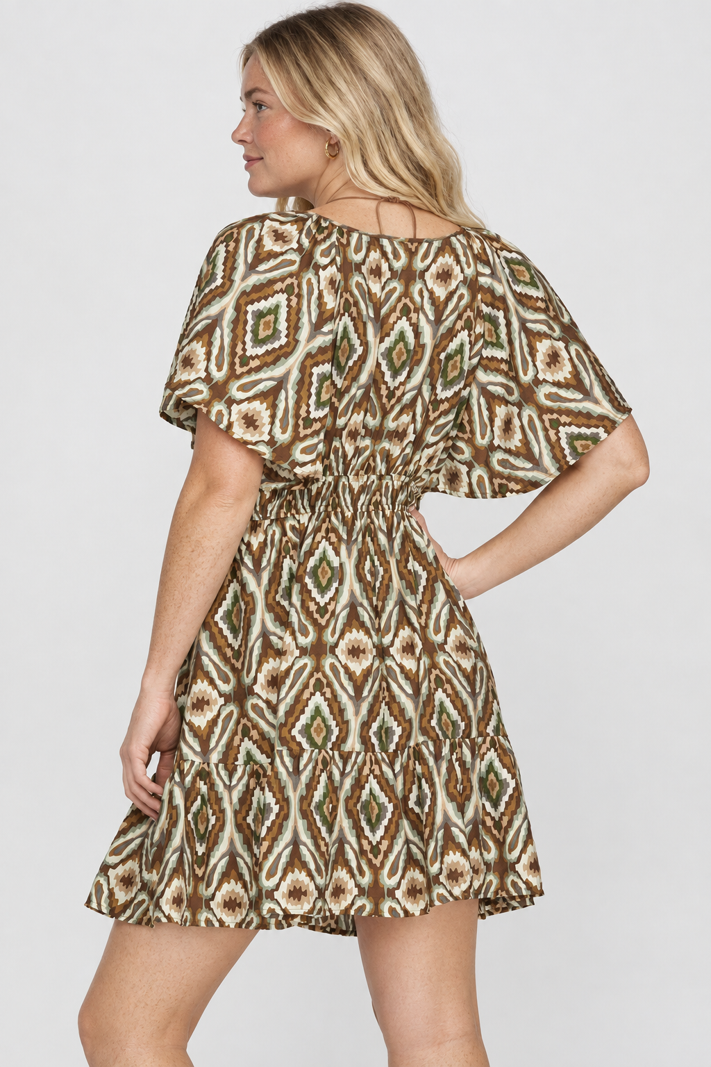 Product photo, blonde model, full back pose, studio background, ikat print dress preserved