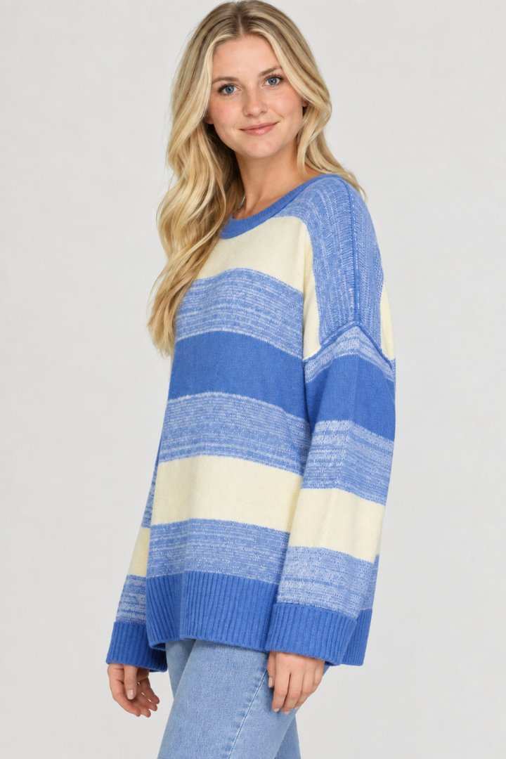 Product photo, blonde model, side pose face forward, studio background, blue and cream striped sweater preserved