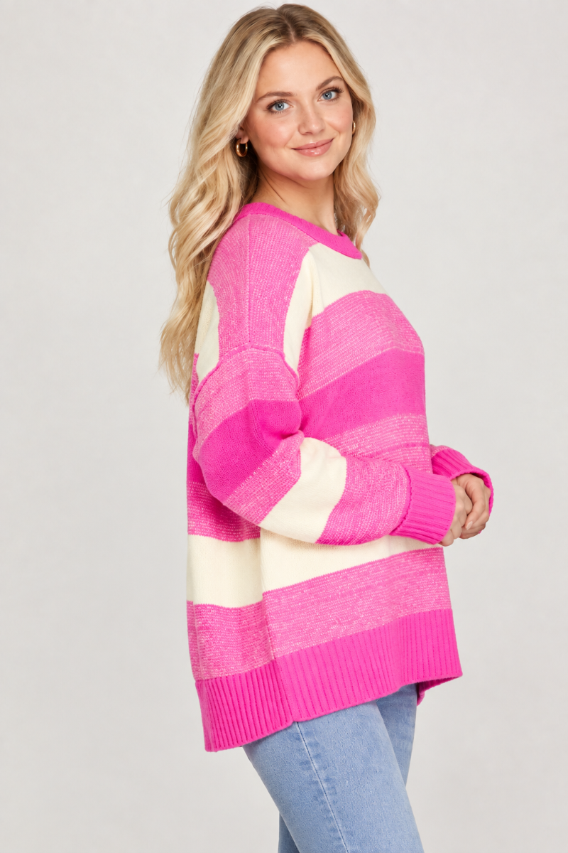 Product photo, blonde model, side pose face forward, studio background, pink and cream striped sweater preserved