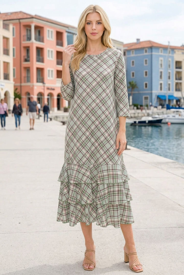 Regular-size blonde model wearing the plaid dress on a waterfront promenade
