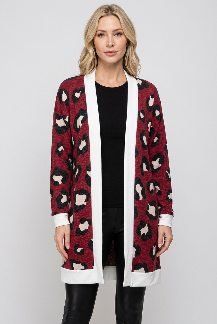 Regular-size blonde model without a beanie wearing the burgundy leopard cardigan