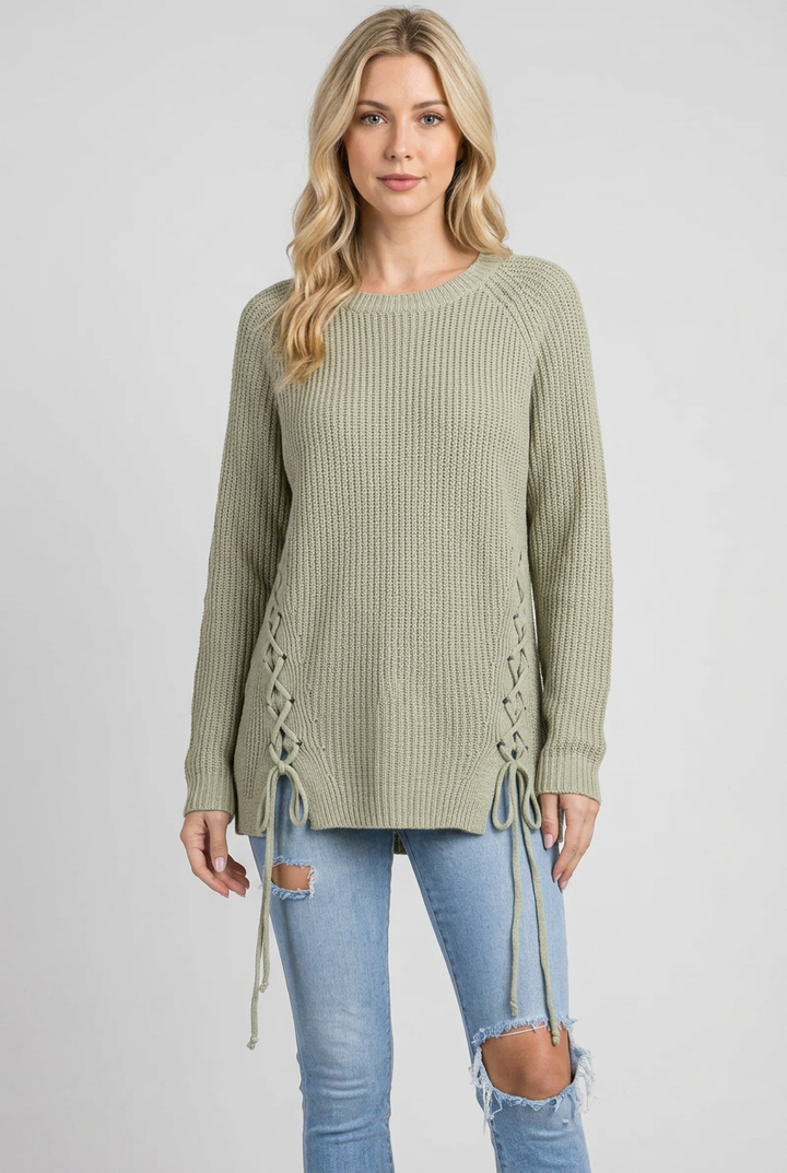 Regular-size blonde model without a beanie wearing the sage lace-up sweater