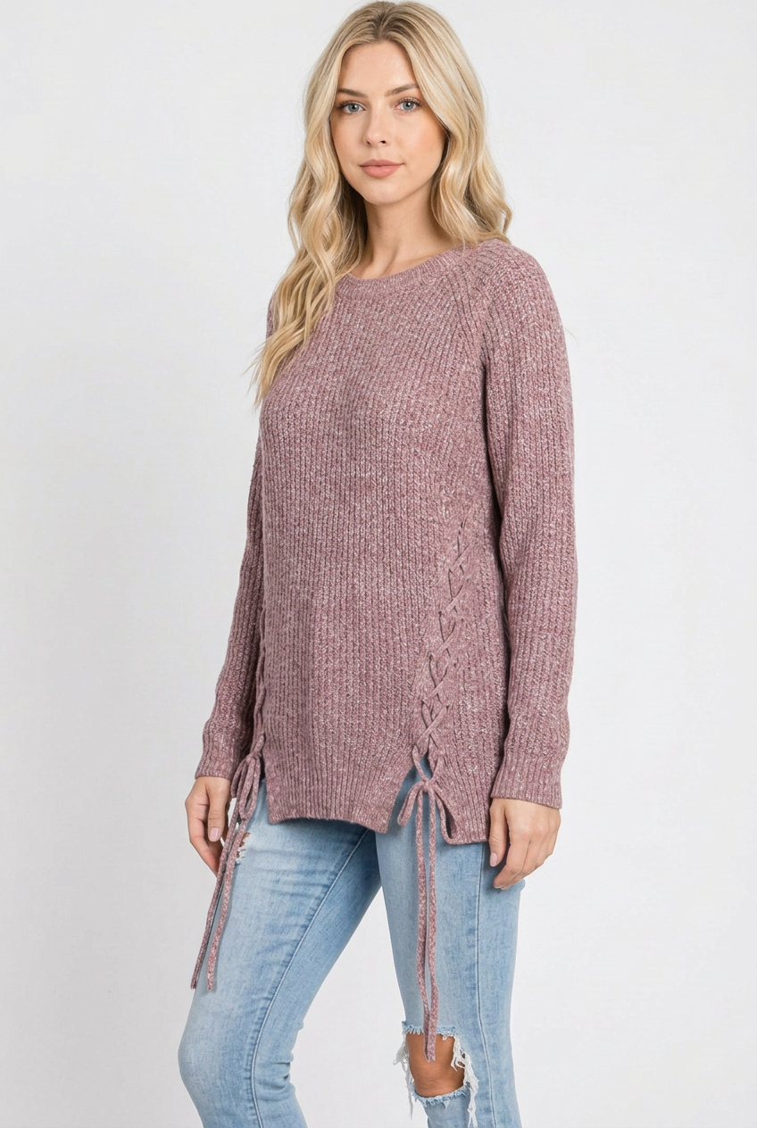 Side studio pose of the blonde model wearing the mauve lace-up sweater