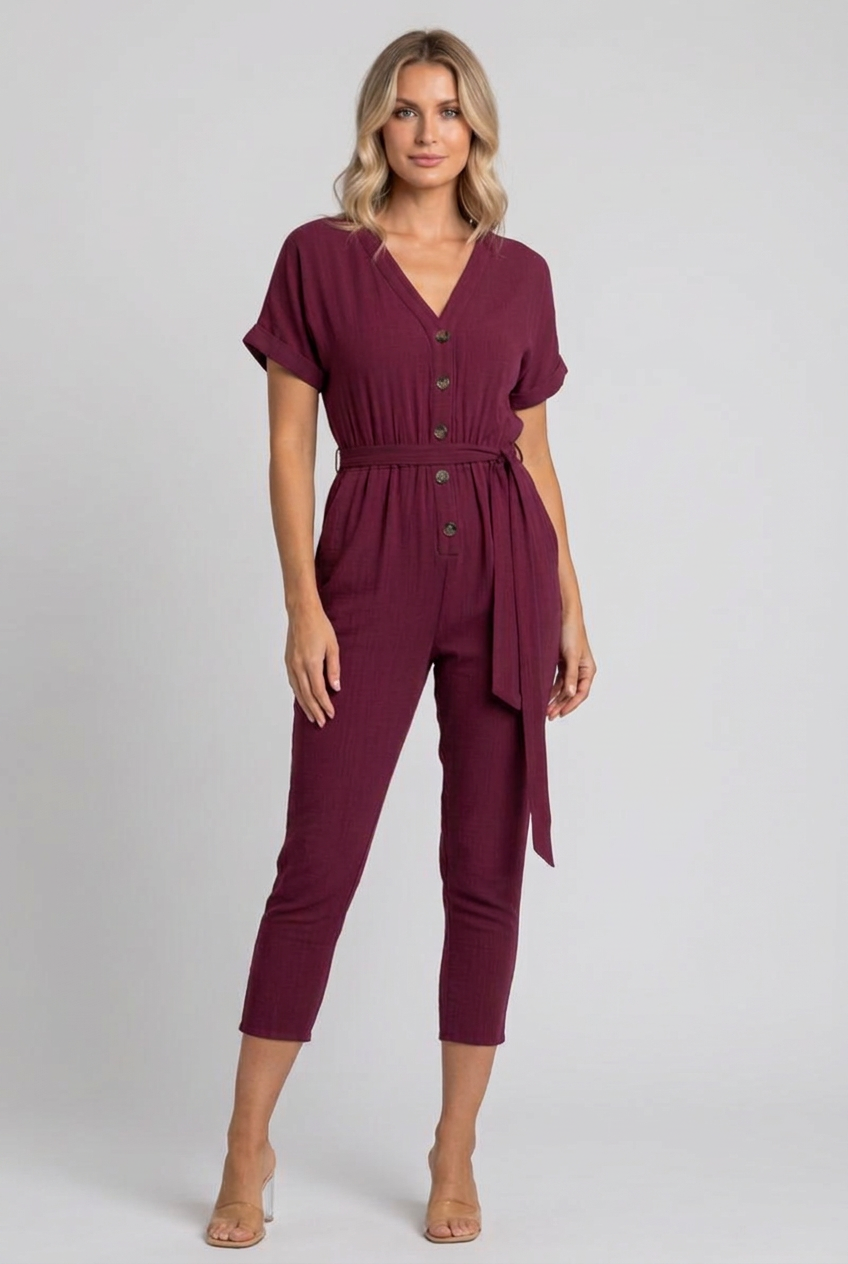 Side studio pose wearing the burgundy cropped jumpsuit