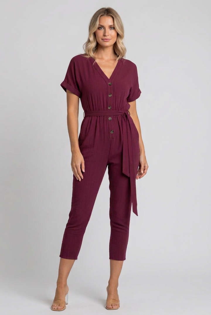 Side studio pose wearing the burgundy cropped jumpsuit