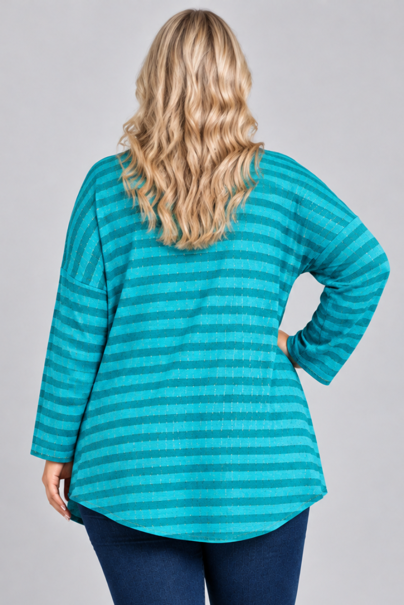 Studio back view of blonde model in a loose teal striped top and dark jeans