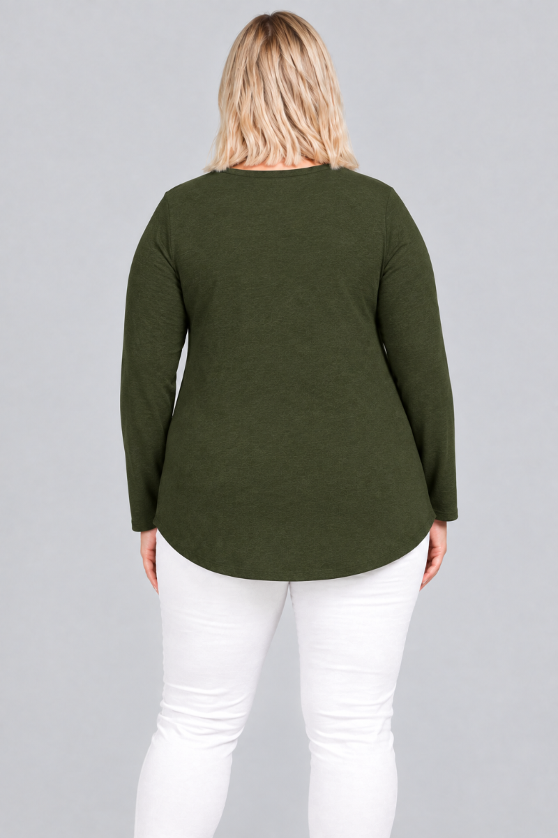 Studio back view of blonde model in dark olive tunic and white pants