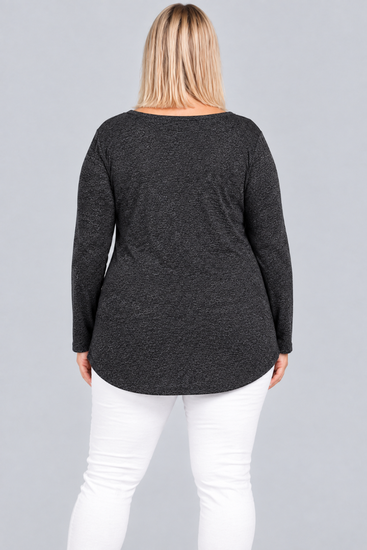 Studio back view of blonde model wearing charcoal heather tunic and white pants