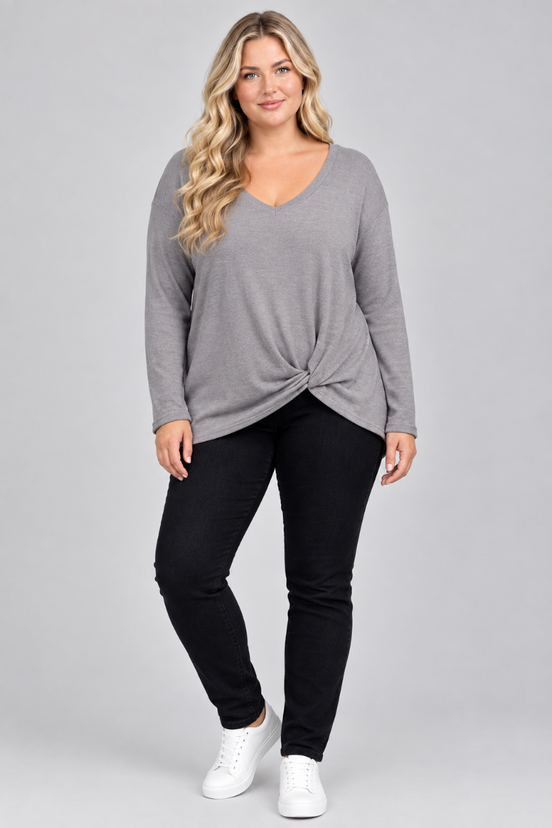 Studio front view of a blonde curvy XL model wearing the gray twist-front top and black pants