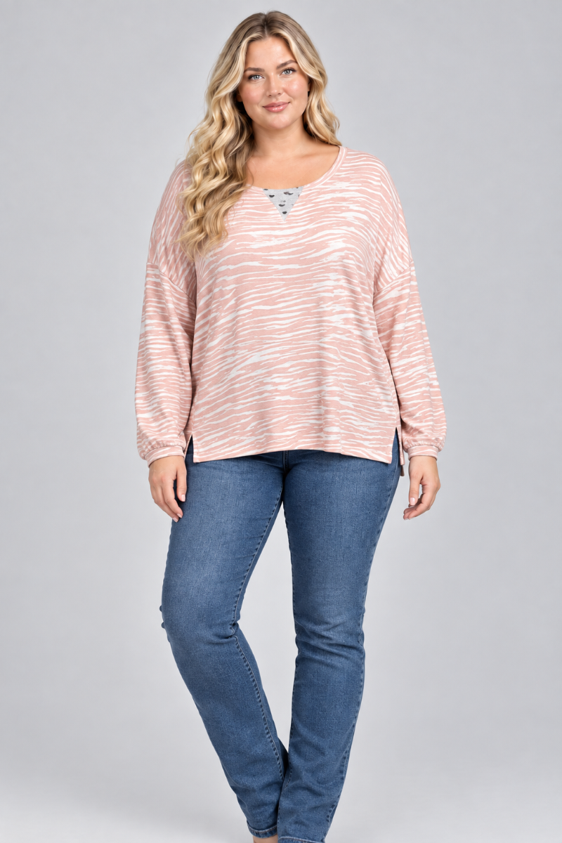 Studio front view of the blonde XL model wearing the blush striped top and blue jeans