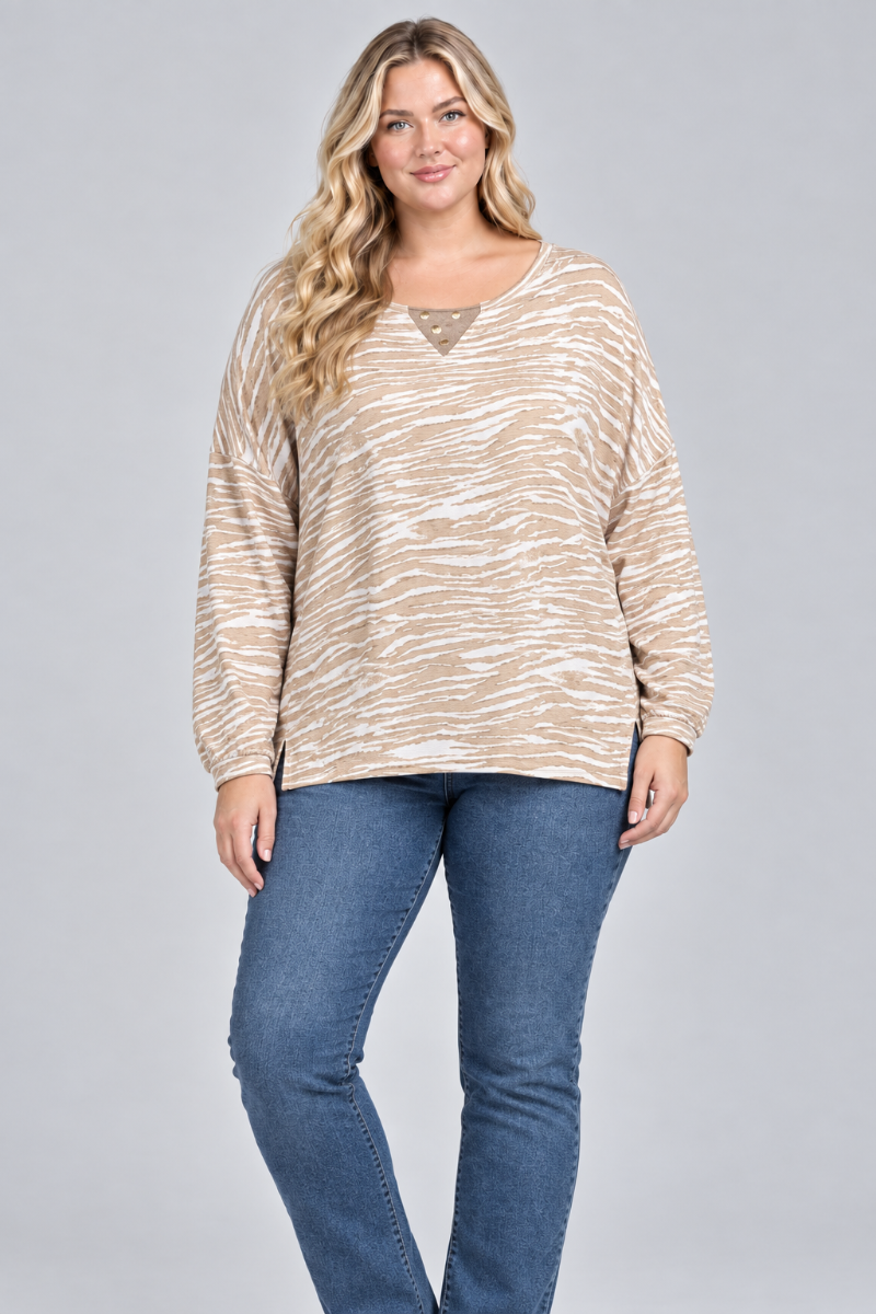 Studio front view of the blonde XL model wearing the taupe-and-cream patterned top and blue jeans