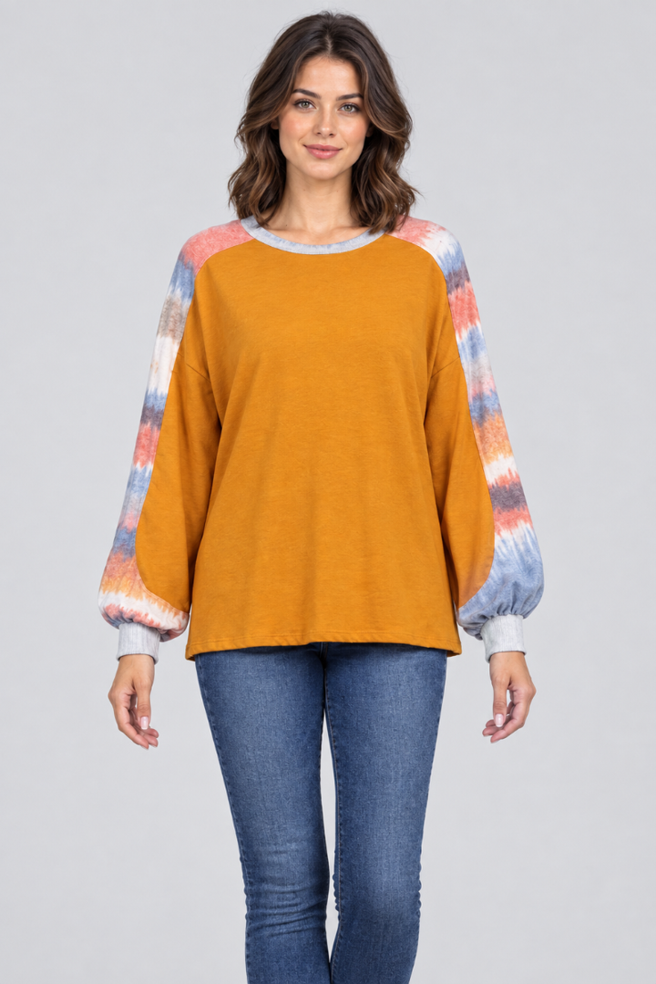Studio front view of the mustard-orange top with tie-dye sleeves