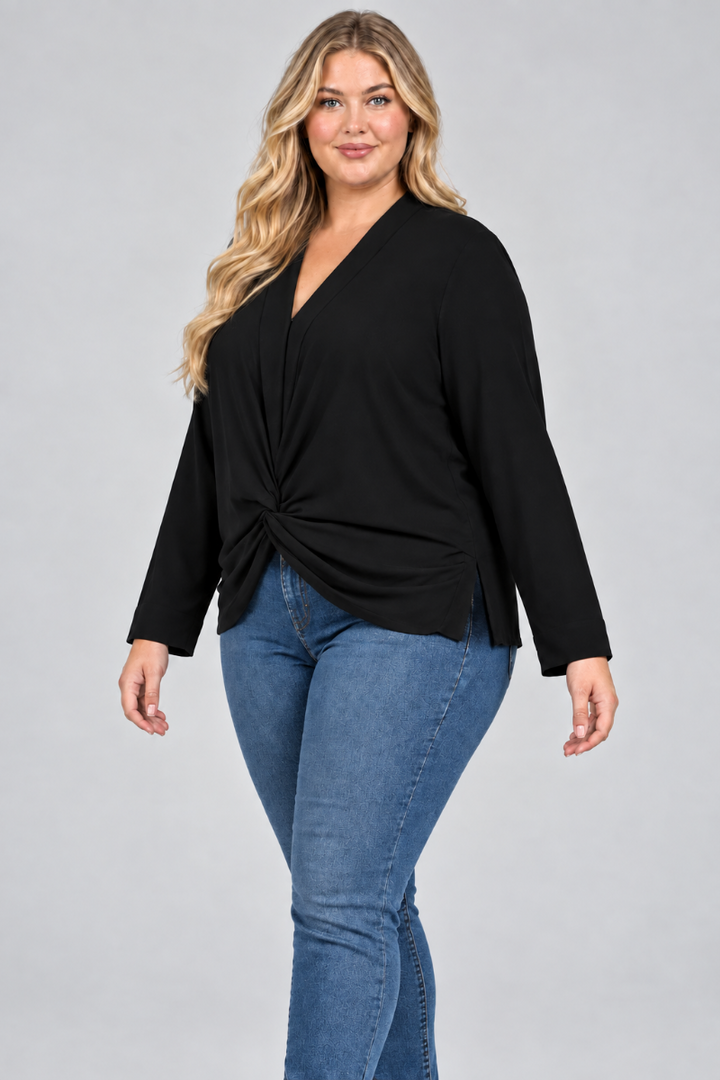 Three-quarter studio view of a plus-size blonde model in the black V-neck blouse and pants